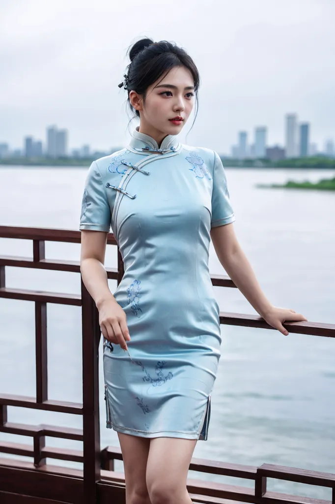 A young woman is wearing a blue cheongsam. The cheongsam is a traditional Chinese dress that is typically worn by women. It is a one-piece dress that is fitted to the body and has a high collar. The cheongsam is often made of silk or other luxurious fabrics and is often decorated with intricate designs. The woman in the picture is wearing a blue cheongsam that is decorated with white and pink flowers. She is also wearing a pair of white high heels. The woman is standing on a wooden railing and is looking out at the water. There are tall buildings in the background.