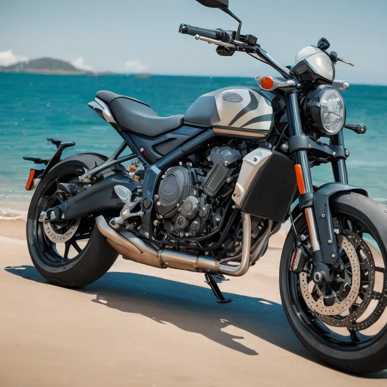 The image shows a black and gray motorcycle parked on a beach. The motorcycle is a Triumph Trident 660, and it is parked on the sand, with the ocean in the background. The motorcycle is facing the ocean.