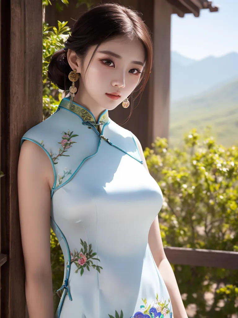 The image shows a young woman wearing a blue cheongsam with floral embroidery. The cheongsam is sleeveless and has a high collar. The woman has her hair in a bun and is wearing traditional Chinese earrings. She is standing in a garden and there are trees and mountains in the background.