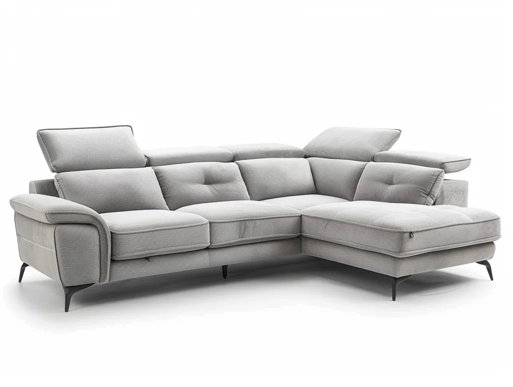 A large, light gray sectional sofa with black metal legs sits on a white background. The sofa has a chaise lounge on the right side and multiple cushions. It appears to be a modern and comfortable design, perfect for lounging.