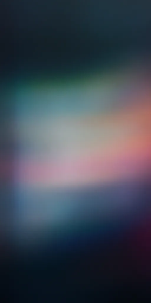 The image is a blurred abstract background with a gradient of dark blue, teal, and pink. The colors are muted and blend together seamlessly, creating a soft and ethereal feel. The lack of detail and sharp edges makes it visually appealing and calming.