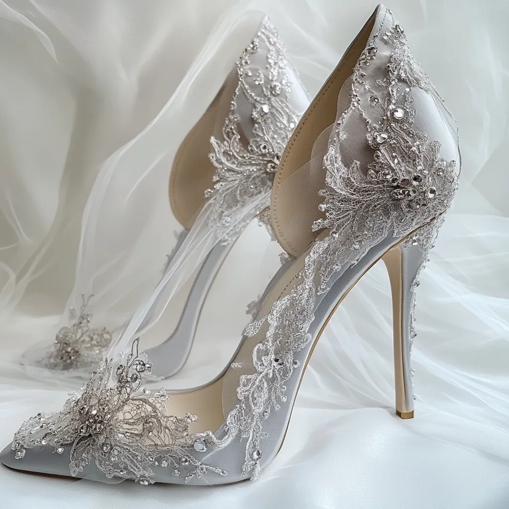 A pair of delicate silver high heels, adorned with intricate lace and sparkling embellishments, rest on a soft white tulle fabric. The shoes are a classic and elegant choice for a special occasion, radiating a sense of glamour and sophistication. The lace details add a touch of femininity and romance, while the sparkling accents add a touch of sparkle and shine.
