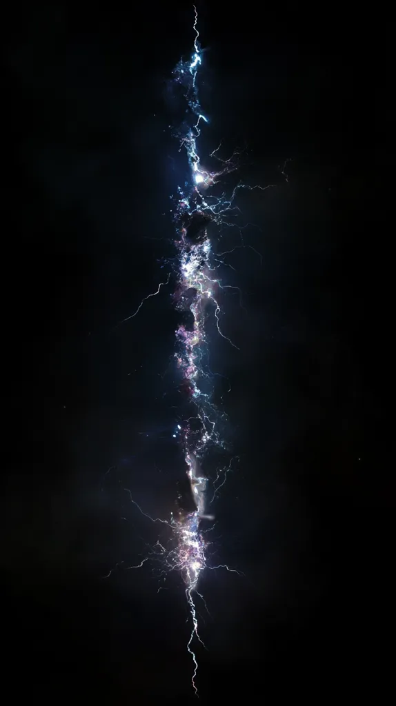 Here's a description of the image:

The image is a dramatic, close-up shot of a lightning strike at night.  The bolt appears as a tall, vertical streak of brilliant white-blue light against a completely black background.  It branches out in thinner, less intense tendrils, creating a visually striking, almost ethereal effect. The lighting suggests a powerful electrical discharge, with the central core of the strike being the brightest and most intense.  The overall impression is one of raw power and natural beauty.