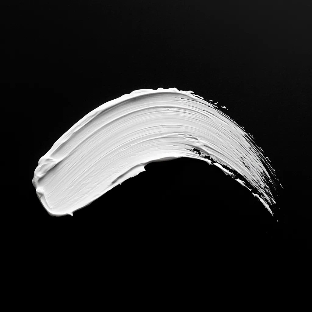 Against a stark black background, a single, dynamic stroke of thick, white paint dominates the image. The paint, applied with visible texture and visible brushstrokes, curves gracefully, creating a sense of movement and fluidity.  The contrast between the white paint and the black backdrop is striking, emphasizing the paint's form and highlighting its creamy consistency. The image is minimalist and visually impactful.