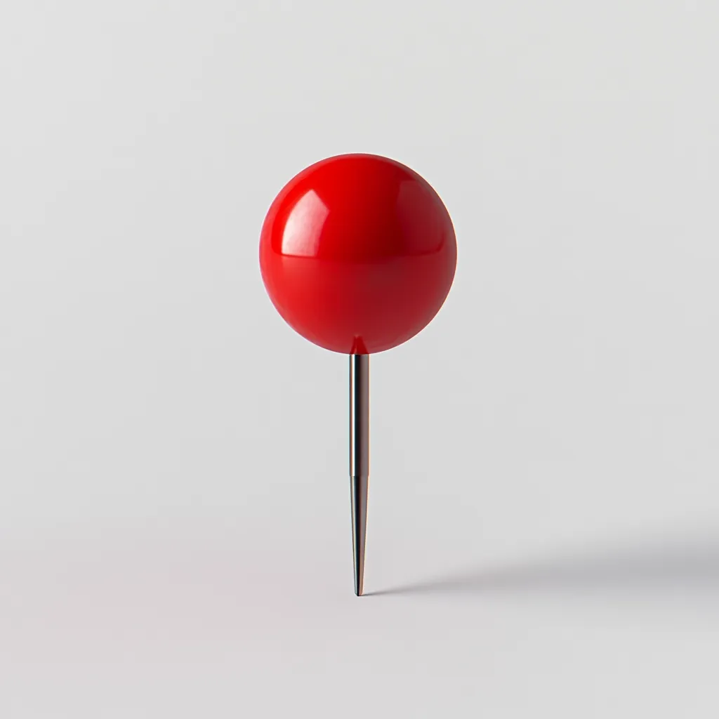 A single, bright red pushpin stands upright against a stark white background. The pin's head is a perfect sphere, glossy and reflective, contrasting sharply with the matte surface beneath. The thin, metallic pin is centrally positioned, creating a simple yet striking visual. The image evokes a sense of minimalism and focus, potentially suggesting a point of interest or a specific location marked.
