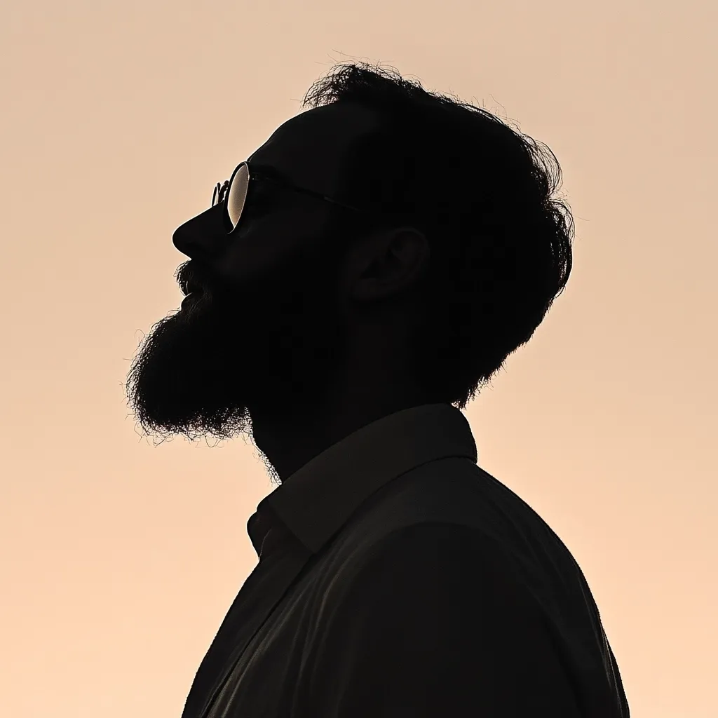 A profile silhouette of a bearded man wearing glasses against a light beige background.  His head is tilted slightly upward, and his expression appears serene.  The silhouette is sharply defined, emphasizing his facial features and the texture of his beard. He is dressed in a collared shirt. The overall image conveys a sense of calm contemplation.