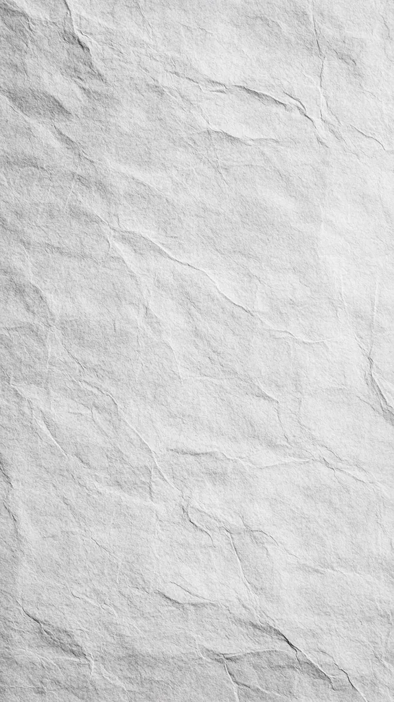 The image shows a close-up view of a textured surface resembling crumpled or folded paper.  The texture is predominantly light gray with varying shades and depths, creating a pattern of wrinkles and creases. The overall effect is one of roughness and irregularity, suggesting a material with a natural or handmade quality. The grayscale palette enhances the textural detail.