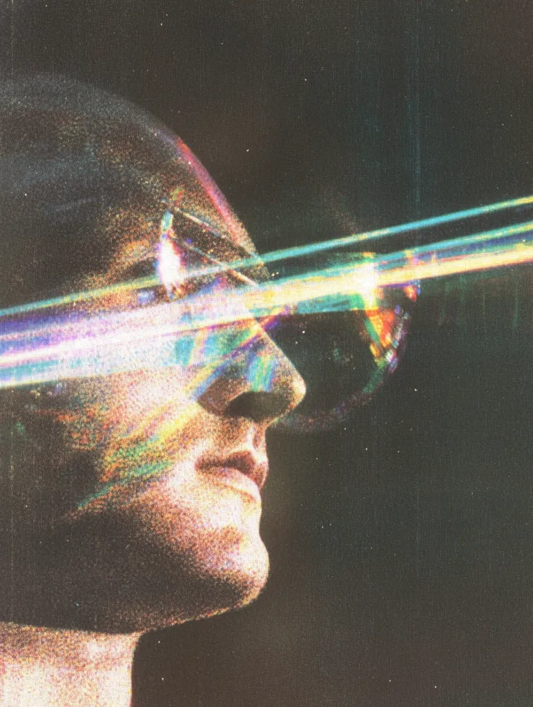 A stylized portrait of a man's profile, partially obscured by vibrant, iridescent streaks of light. The effect is reminiscent of a glitch or light refraction, creating a surreal and otherworldly atmosphere.  The man's face is partially visible, showcasing a contemplative expression. The dark background emphasizes the luminescent streaks. The overall mood is mysterious and evocative.