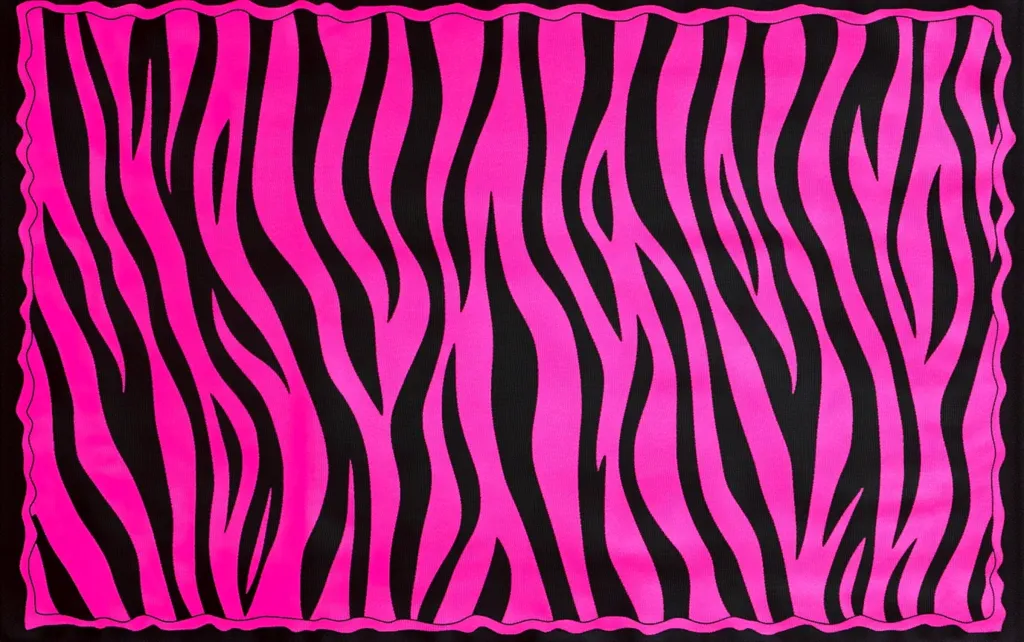 A vibrant pink and black zebra-striped fabric fills the frame. The bold, contrasting colors create a striking pattern. The fabric's edges are subtly scalloped, adding a touch of decorative flair.  The overall impression is one of energetic and playful design.