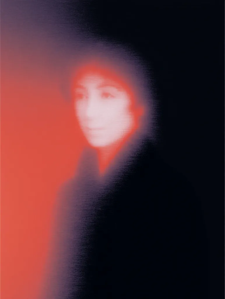 The image is an abstract portrait of a woman.  Her face is blurred and indistinct, rendered in shades of red and white against a dark background. The overall effect is dreamy and ethereal, with a textured, almost grainy quality to the image. The colors and blur create a sense of mystery and ambiguity surrounding the subject.