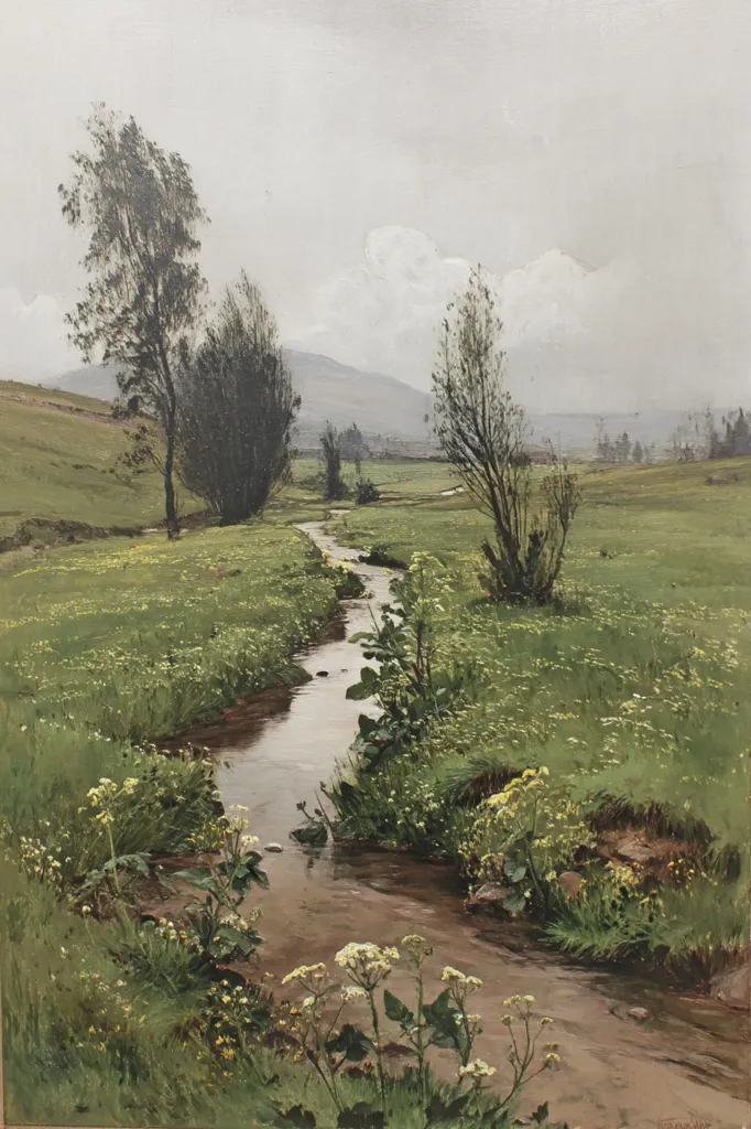A tranquil stream meanders through a verdant meadow under a muted sky.  Sparse trees dot the landscape, their silhouettes stark against the soft light.  Yellow wildflowers bloom along the stream's banks, adding pops of color to the muted greens. Distant hills fade into the hazy atmosphere, creating a serene and peaceful scene. The overall mood is calm and reflective, suggesting a quiet moment in nature.