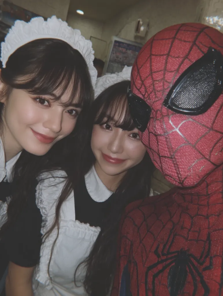 A close-up shot captures two young women dressed as maids, flanking a person in a Spider-Man costume.  The maids wear white aprons and headpieces. The image is dimly lit, giving it a slightly nostalgic or vintage feel. The Spider-Man costume is detailed and realistic. The photo conveys a playful and fun atmosphere, suggesting a casual encounter or event.