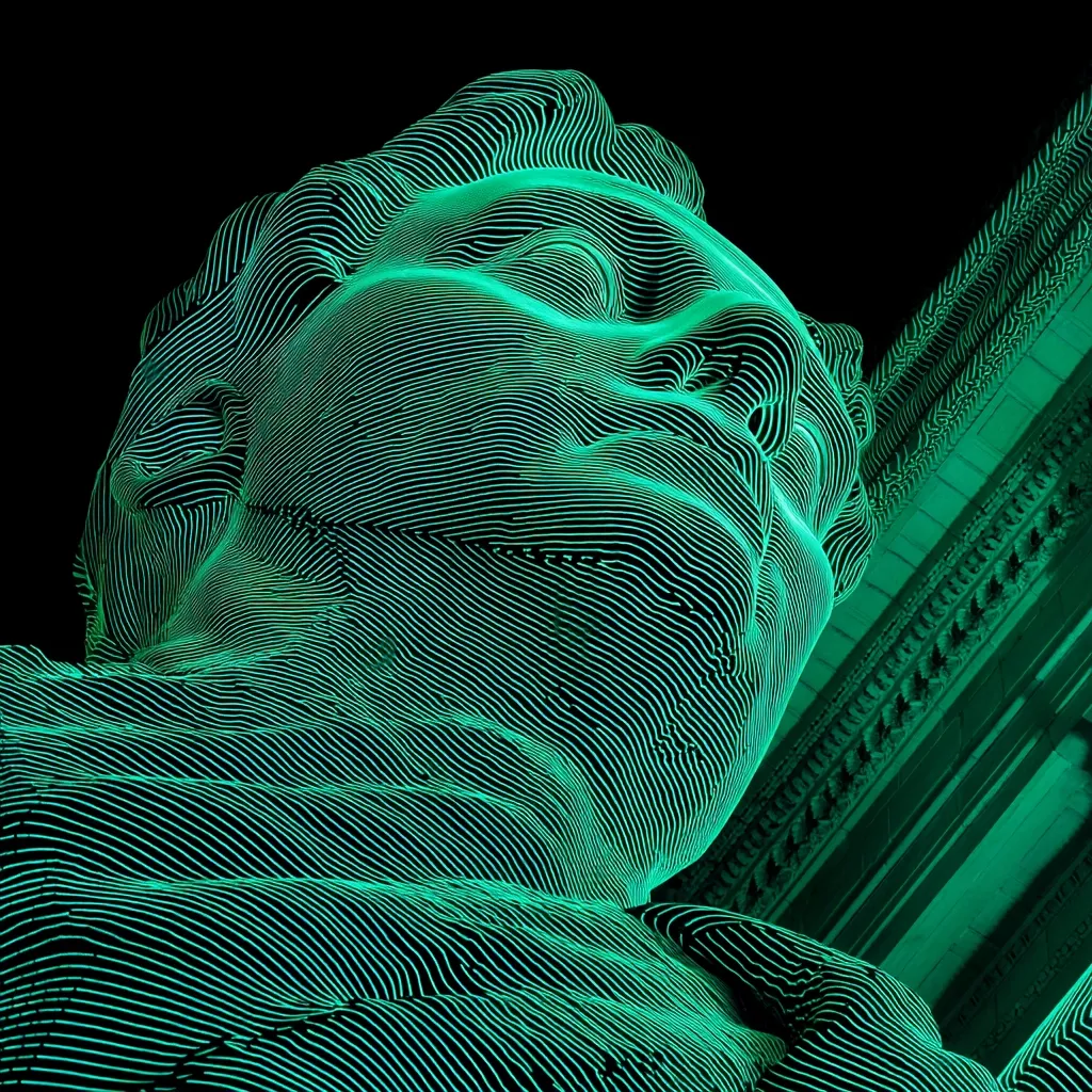A close-up view of a large-scale sculpture, illuminated in vibrant teal. The sculpture appears to be a stylized head and shoulders, rendered in a pattern of intersecting lines creating a three-dimensional effect. The lines suggest a flowing, almost fluid texture. The background is dark, allowing the sculpture's luminescence to stand out prominently.  The style is modern and abstract.