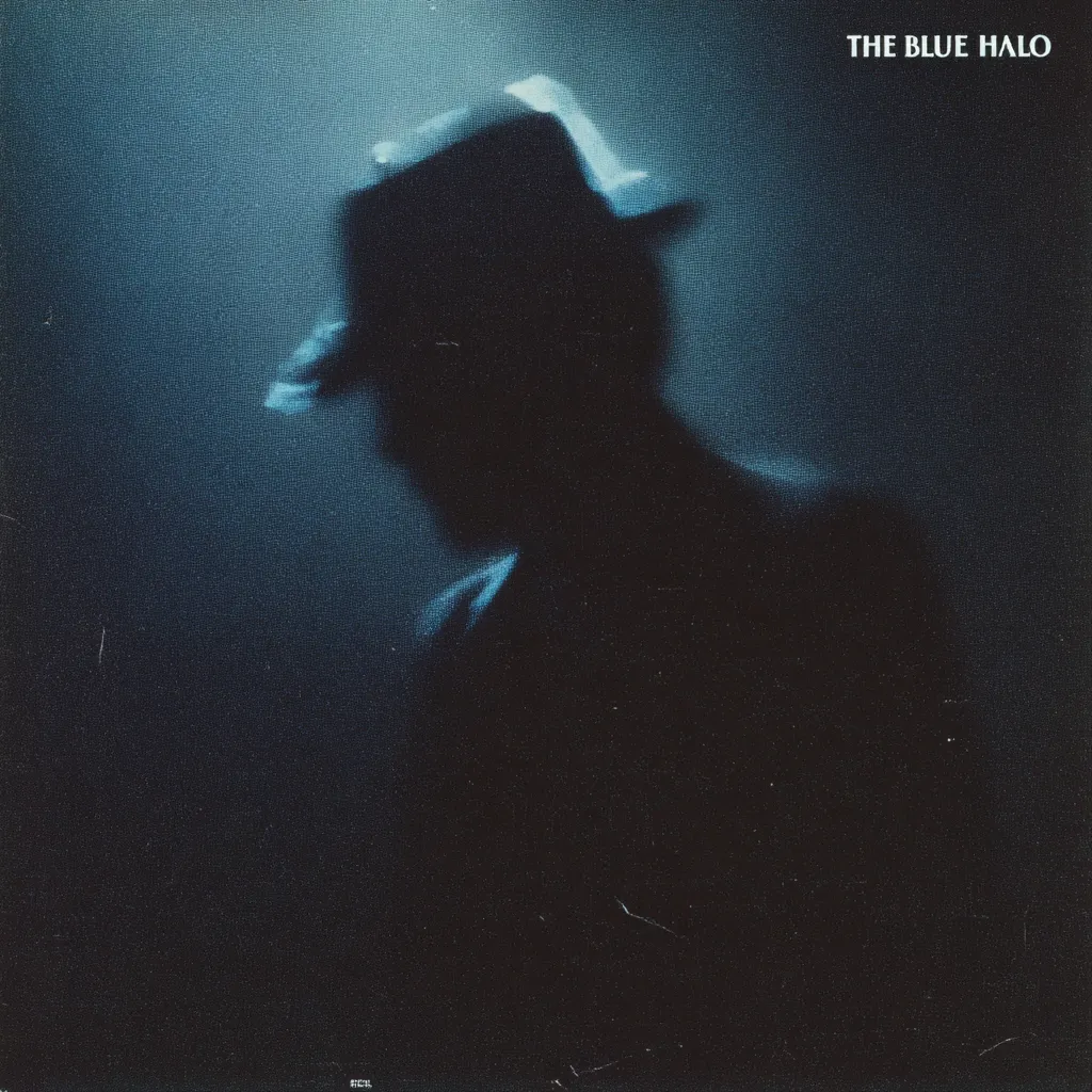 A blurry, shadowy figure of a person wearing a hat dominates the image, set against a dark, moody background.  The figure is indistinct, almost ethereal, with only the outline of the hat and coat clearly visible.  The title "THE BLUE HALO" is displayed in the upper right corner, suggesting a mysterious or atmospheric theme. The overall effect is one of intrigue and ambiguity.