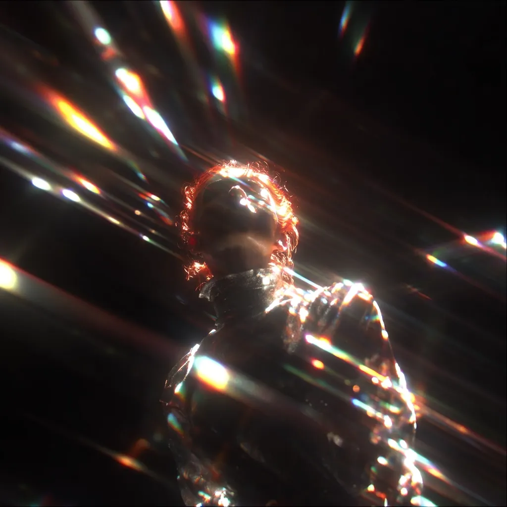 A low-angle shot captures a person with reddish hair, their face partially obscured by streaks of vibrant, iridescent light.  The figure appears to be wearing dark clothing, and the overall effect is one of intense, dynamic energy and a futuristic, almost otherworldly atmosphere. The bright, multicolored light streaks create a strong visual contrast against the dark background.