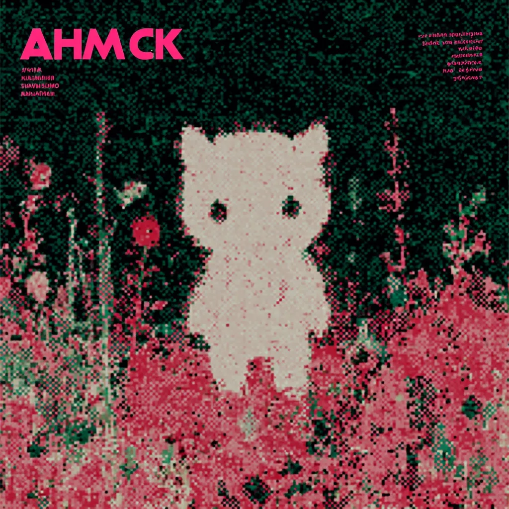The album cover features a pixelized image of a small, white kitten standing amidst a field of vibrant, pixelated pink flowers.  The background is dark, creating a contrast with the bright flowers and the kitten.  The album title "AHMCK" is prominently displayed at the top in stylized lettering, accompanied by smaller text in another language. The overall aesthetic is reminiscent of retro video game graphics.